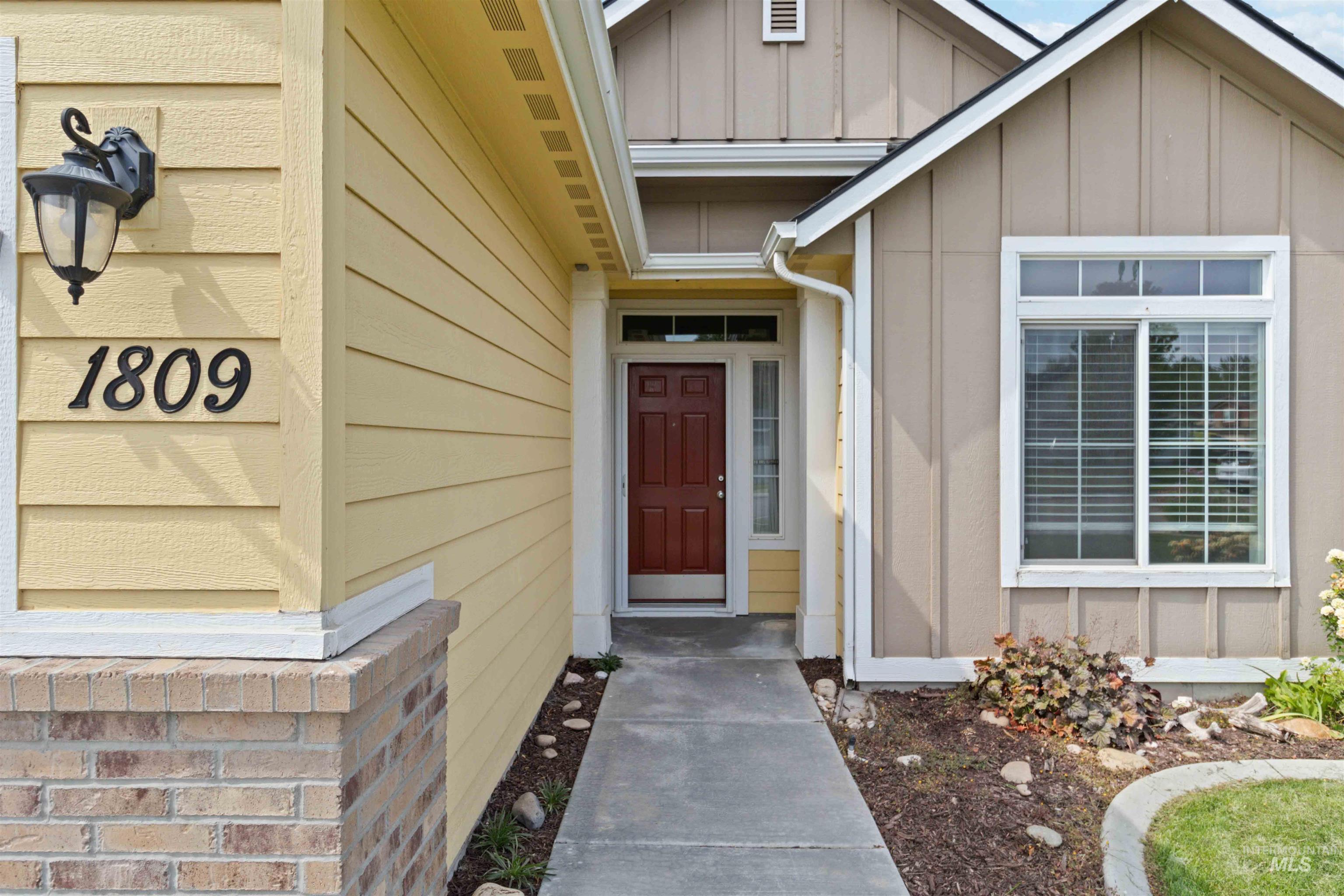 Property entrance featuring board and batten siding
