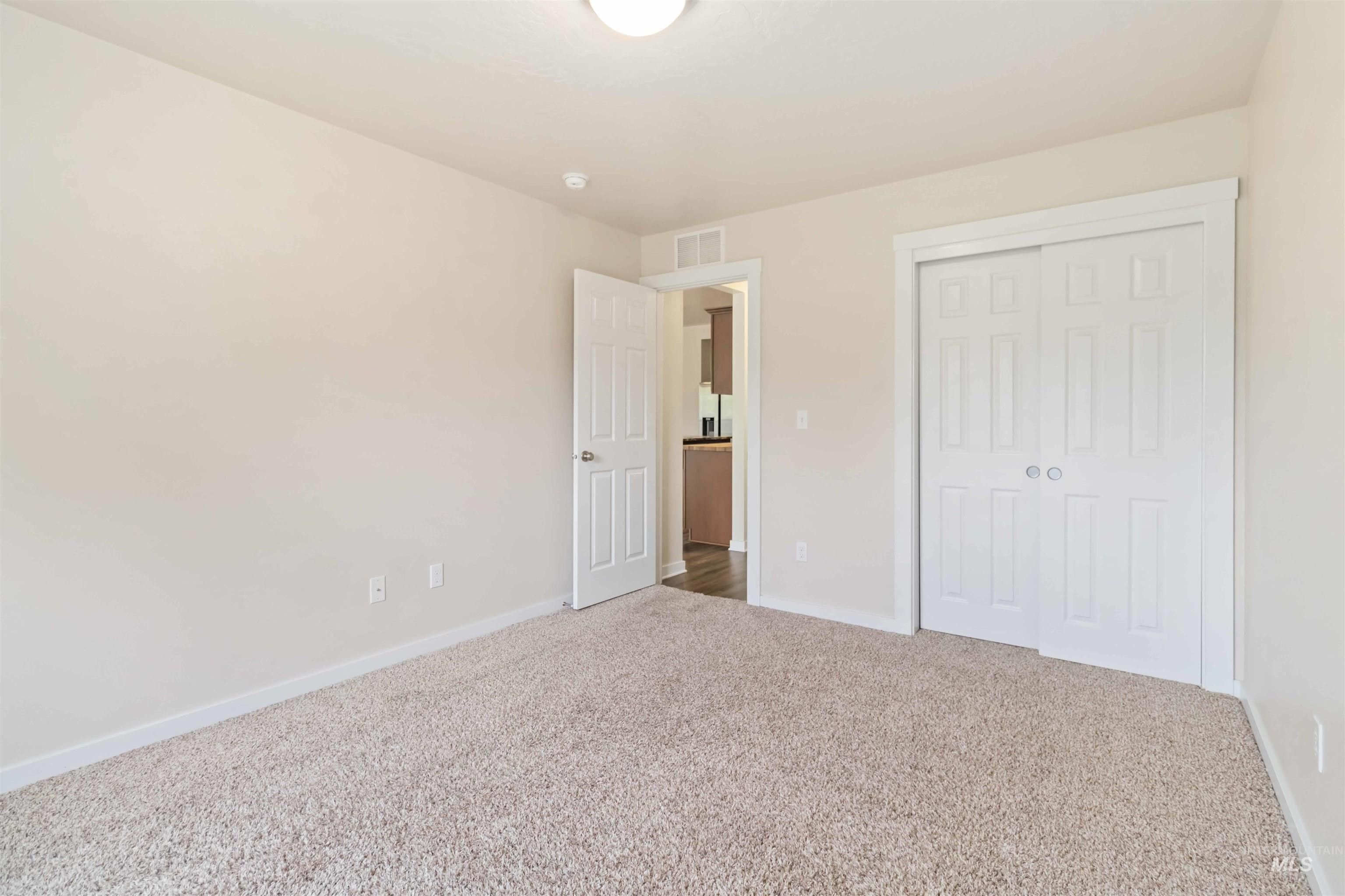 Unfurnished bedroom featuring carpet floors and a closet