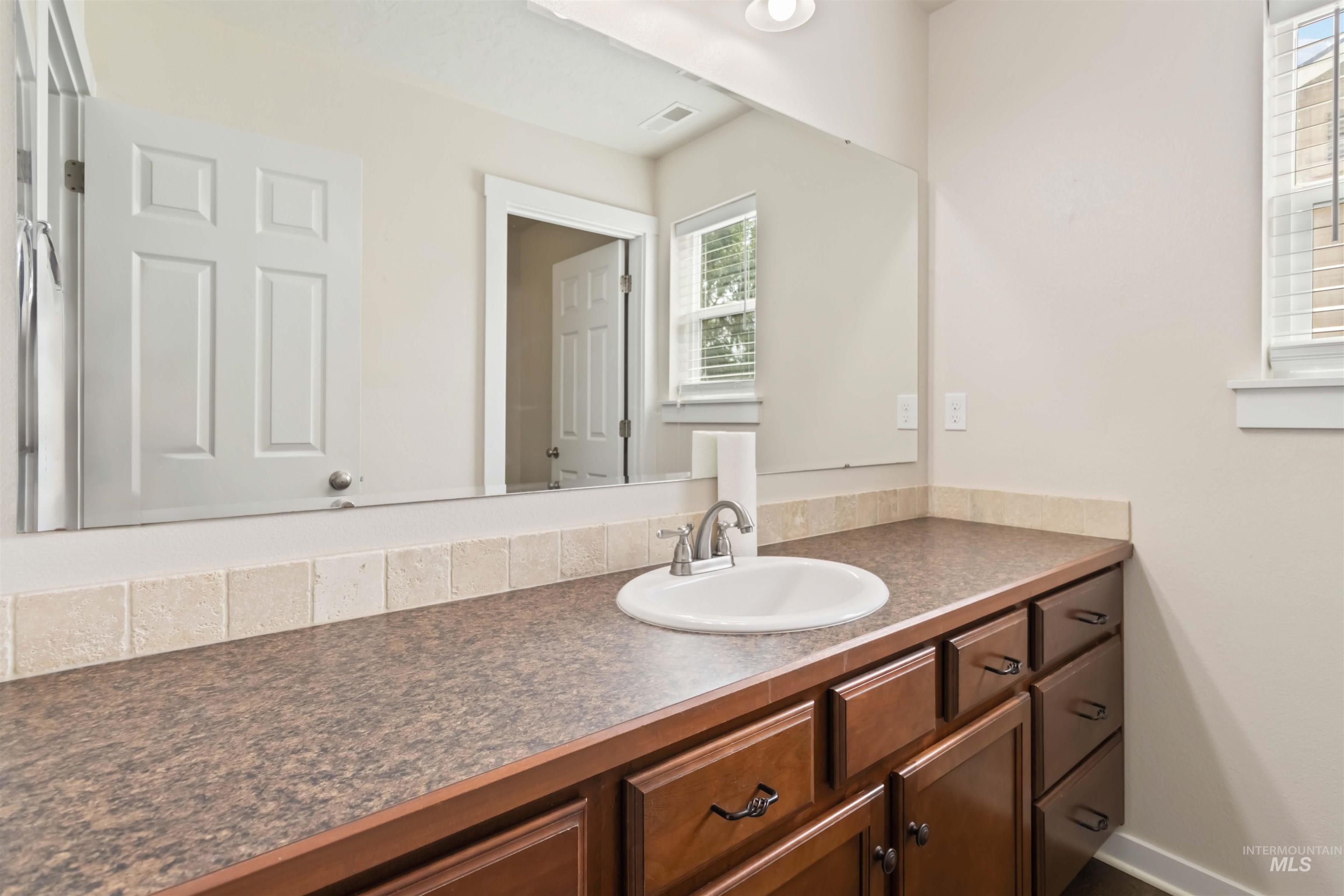 Bathroom with vanity and baseboards