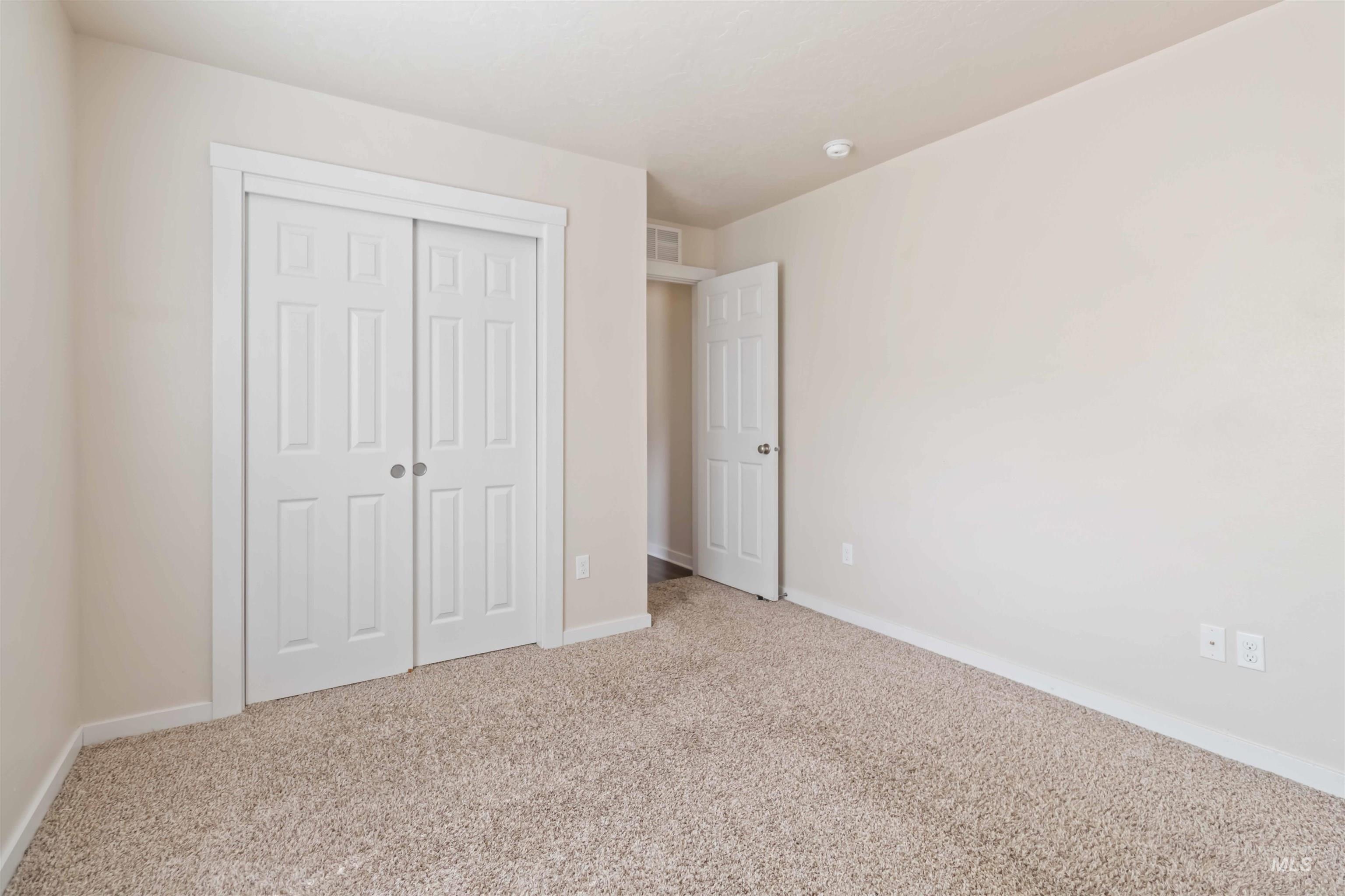 Unfurnished bedroom featuring carpet flooring and a closet