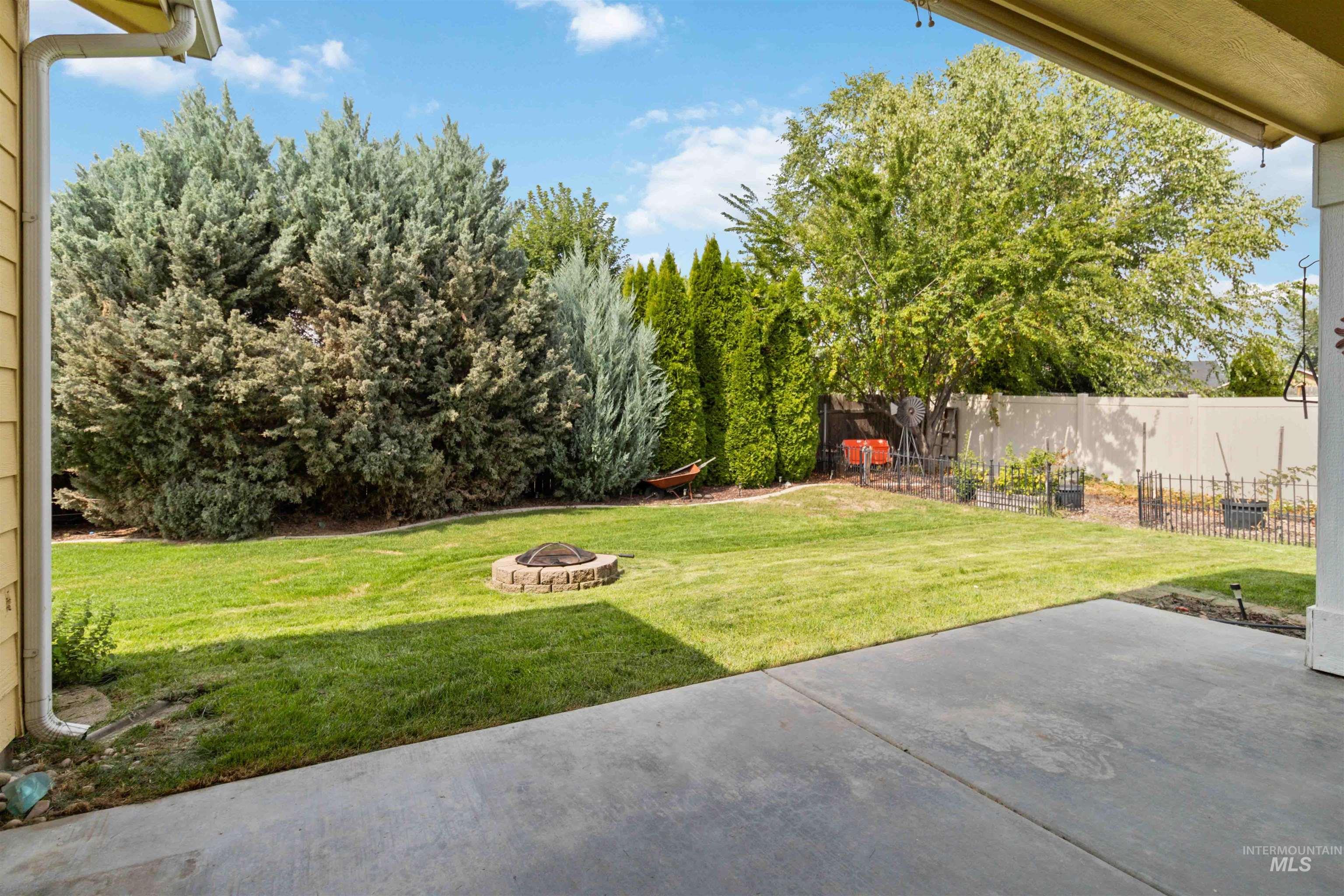 View of yard featuring a patio and a fire pit