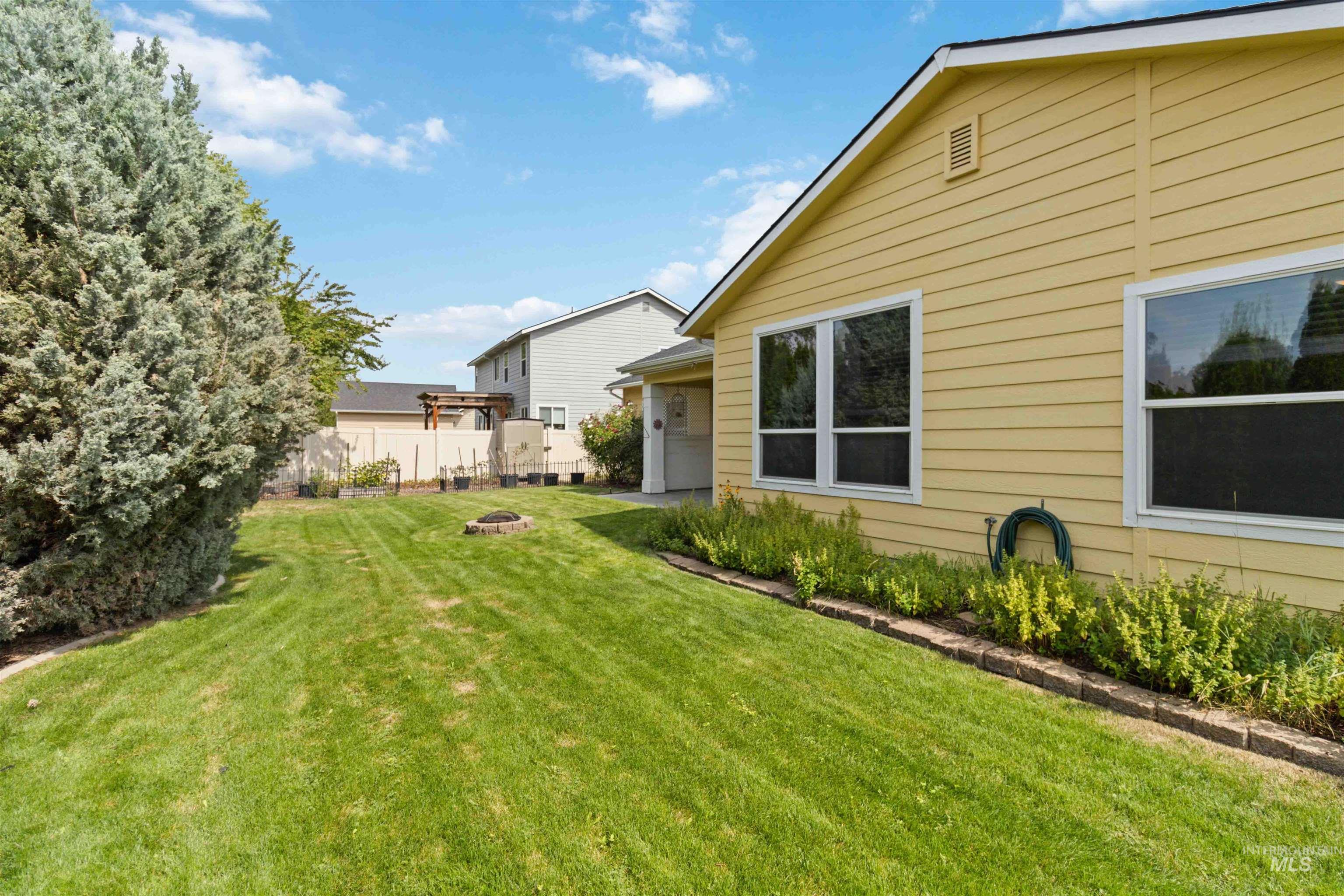View of yard featuring an outdoor fire pit