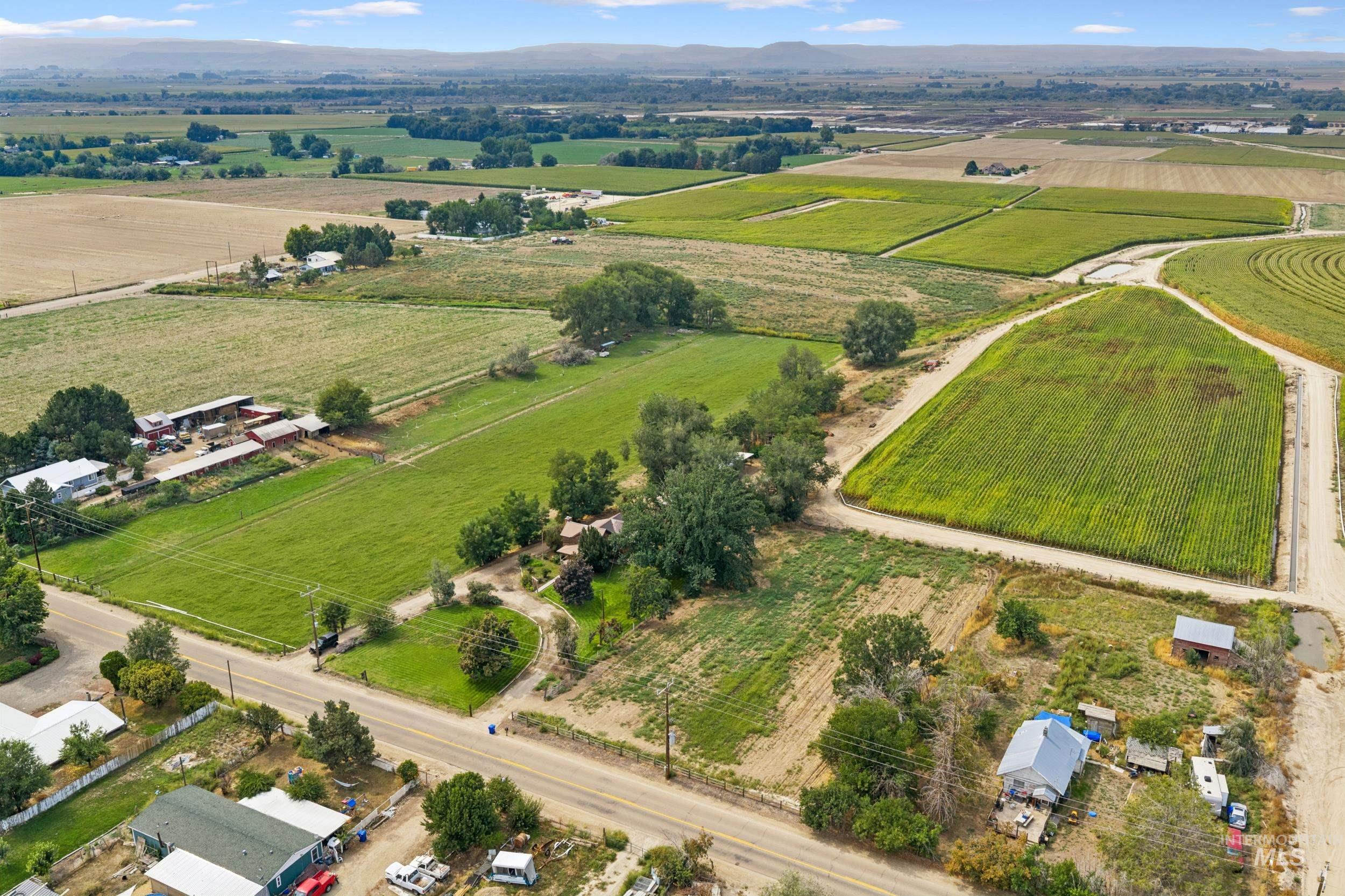 Aerial overview of property's location with rural landscape and rows of crops