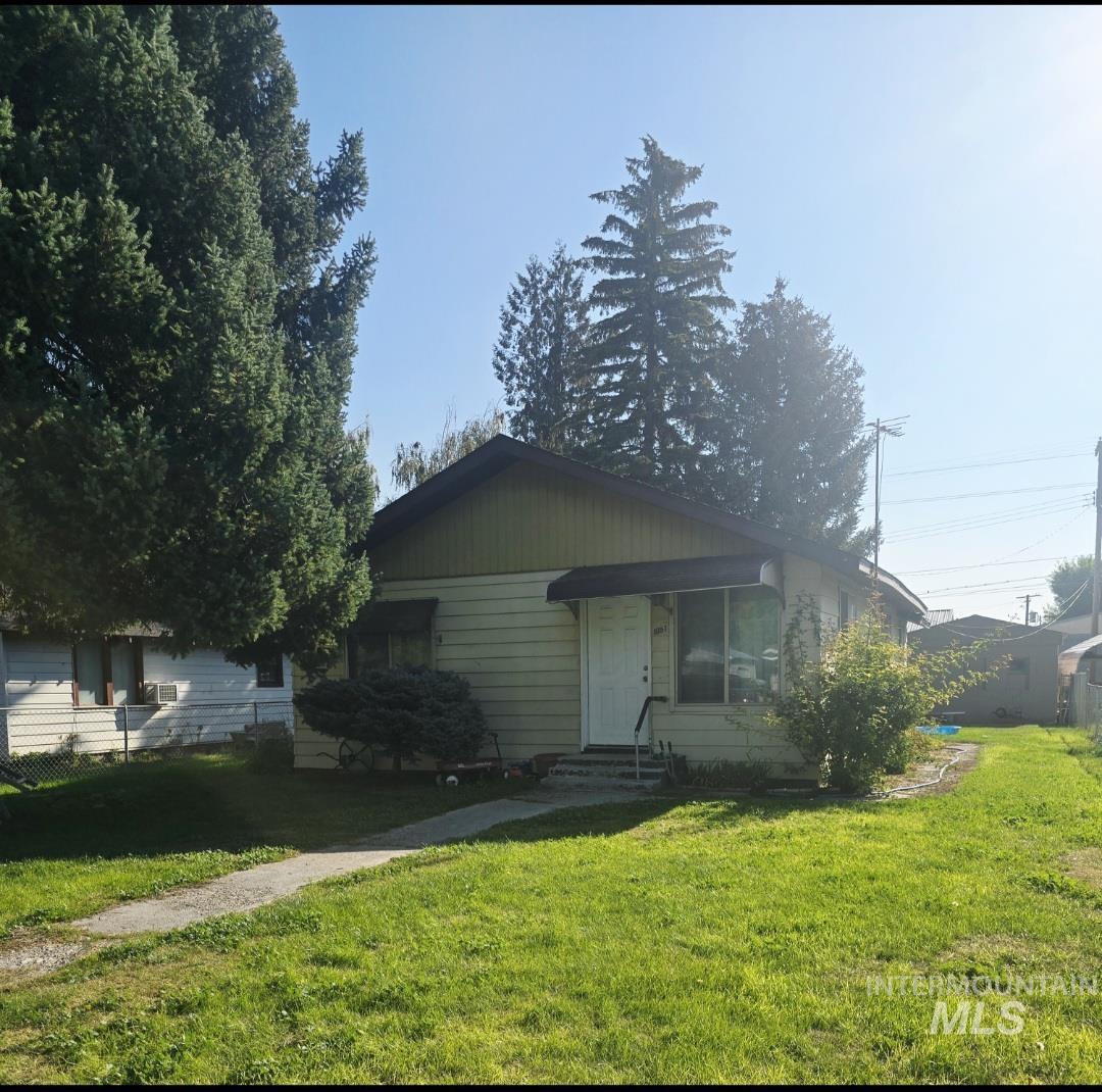 View of front of house with a front yard and entry steps