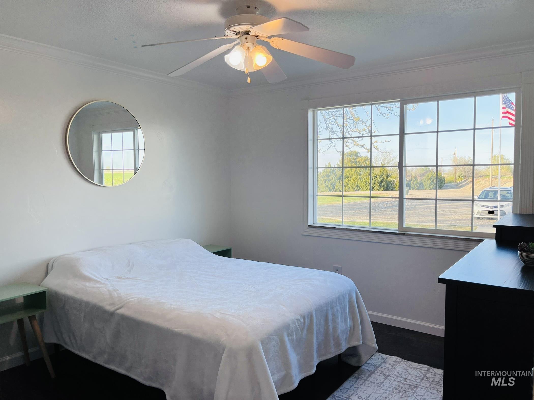 Bedroom with crown molding, a ceiling fan, and a textured ceiling