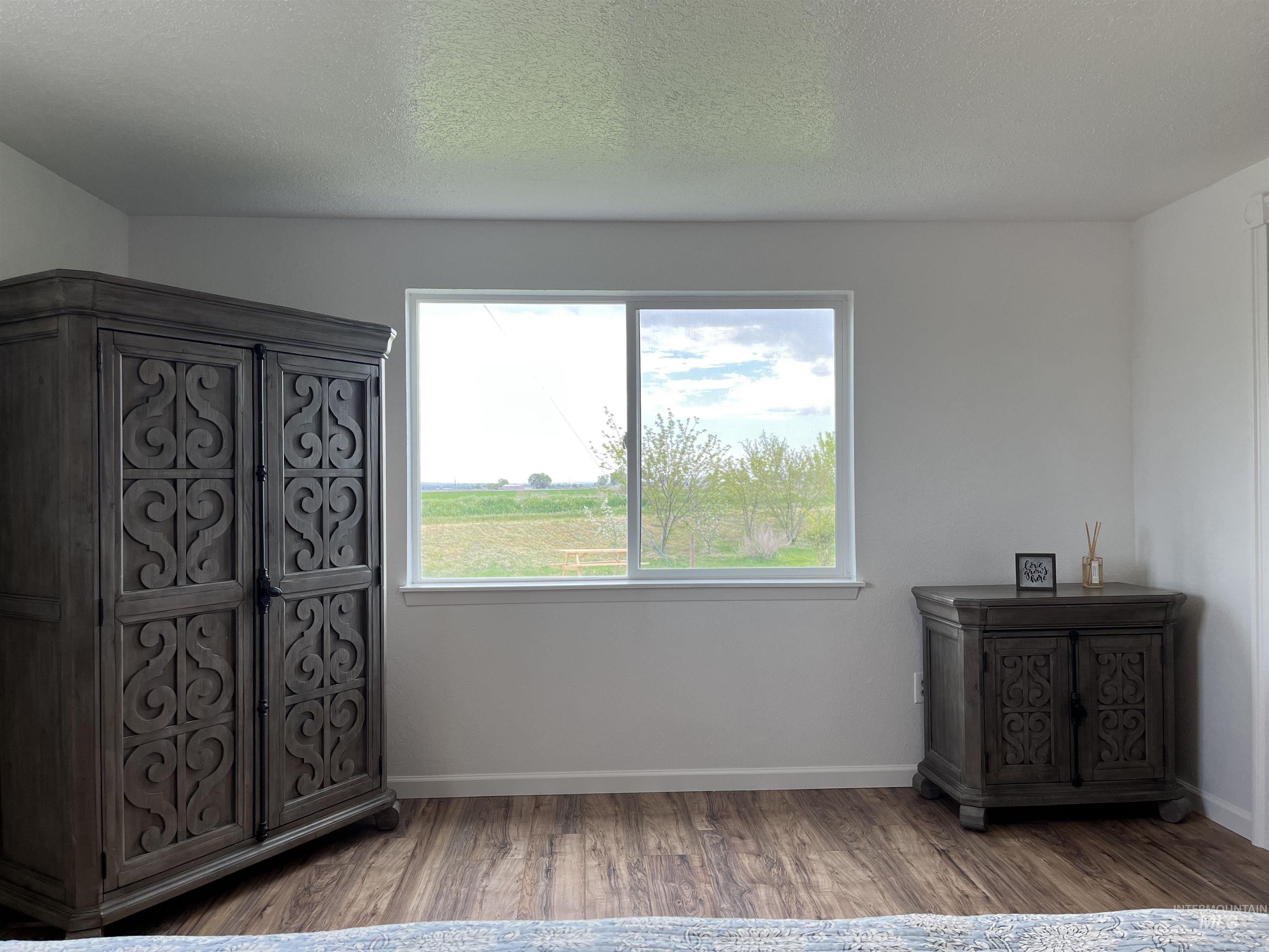 Unfurnished bedroom featuring wood finished floors and a textured ceiling