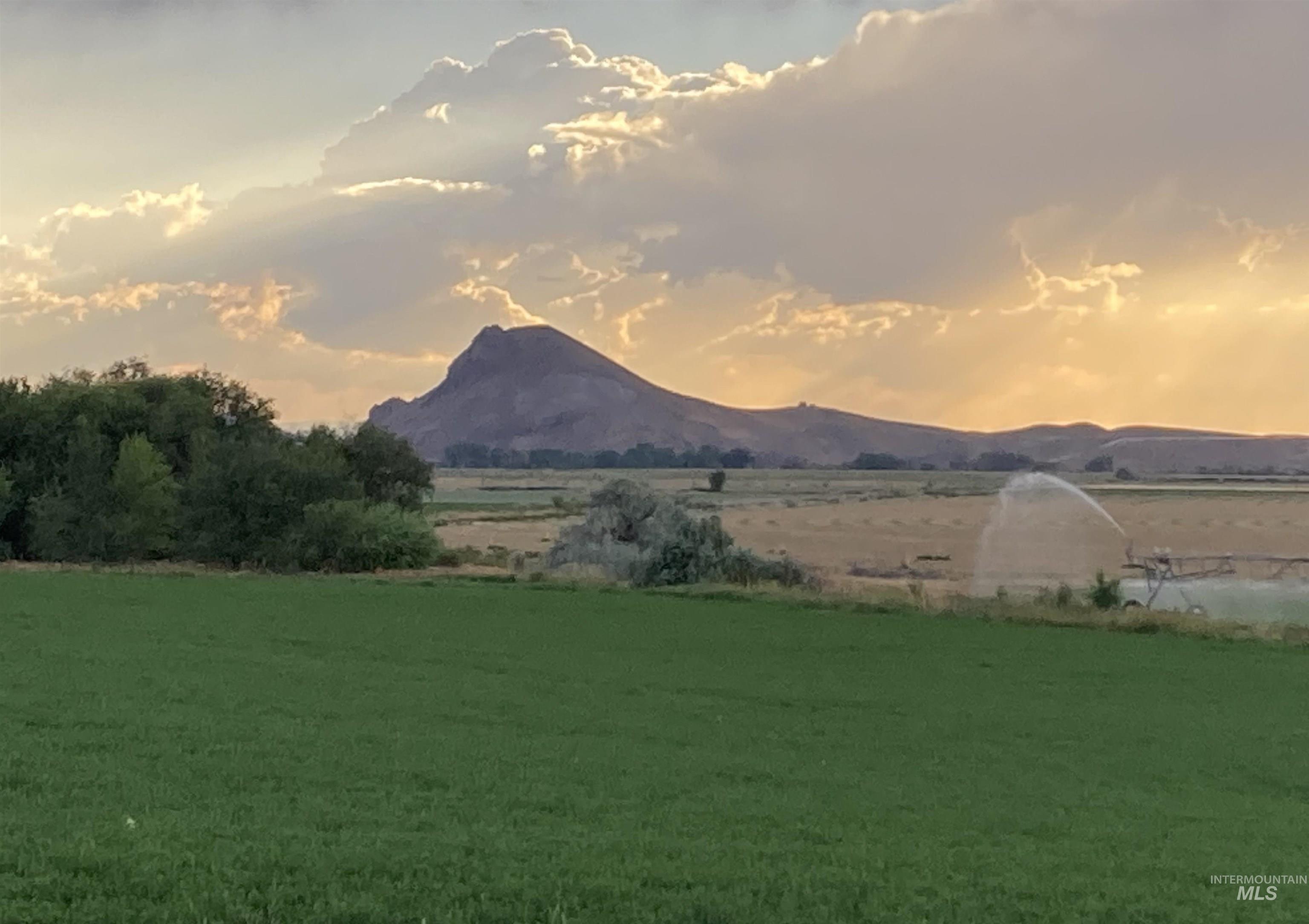 View of mountain backdrop with rural landscape