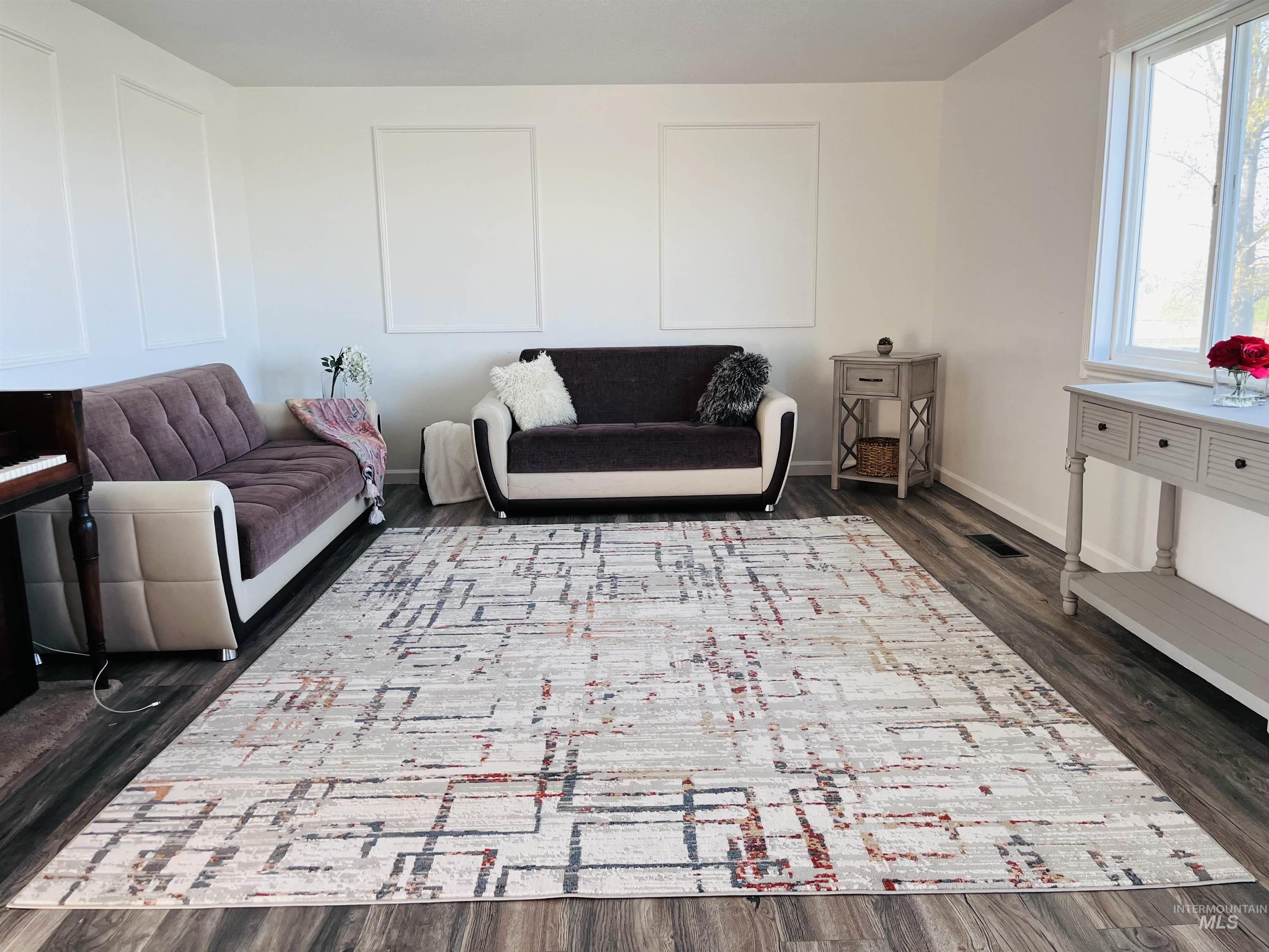 Living room featuring dark wood-style floors