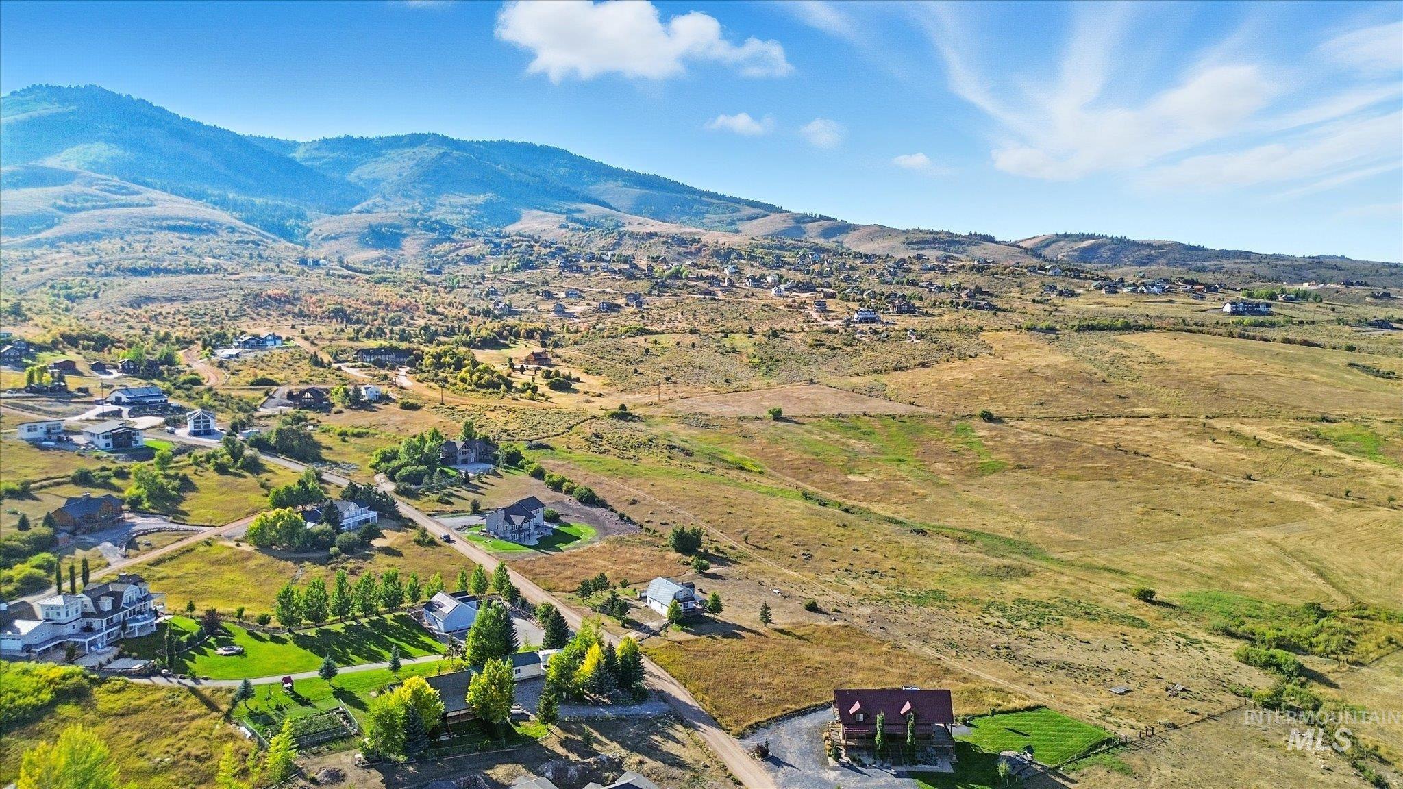View of property location featuring a mountainous background and rural landscape