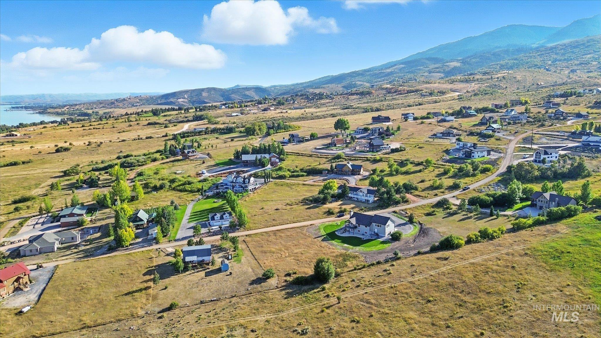 Aerial overview of property's location featuring a mountainous background and nearby suburban area