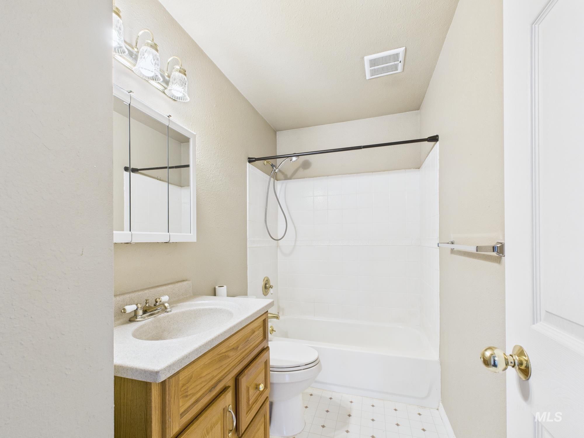 Bathroom with shower / bath combination and vanity