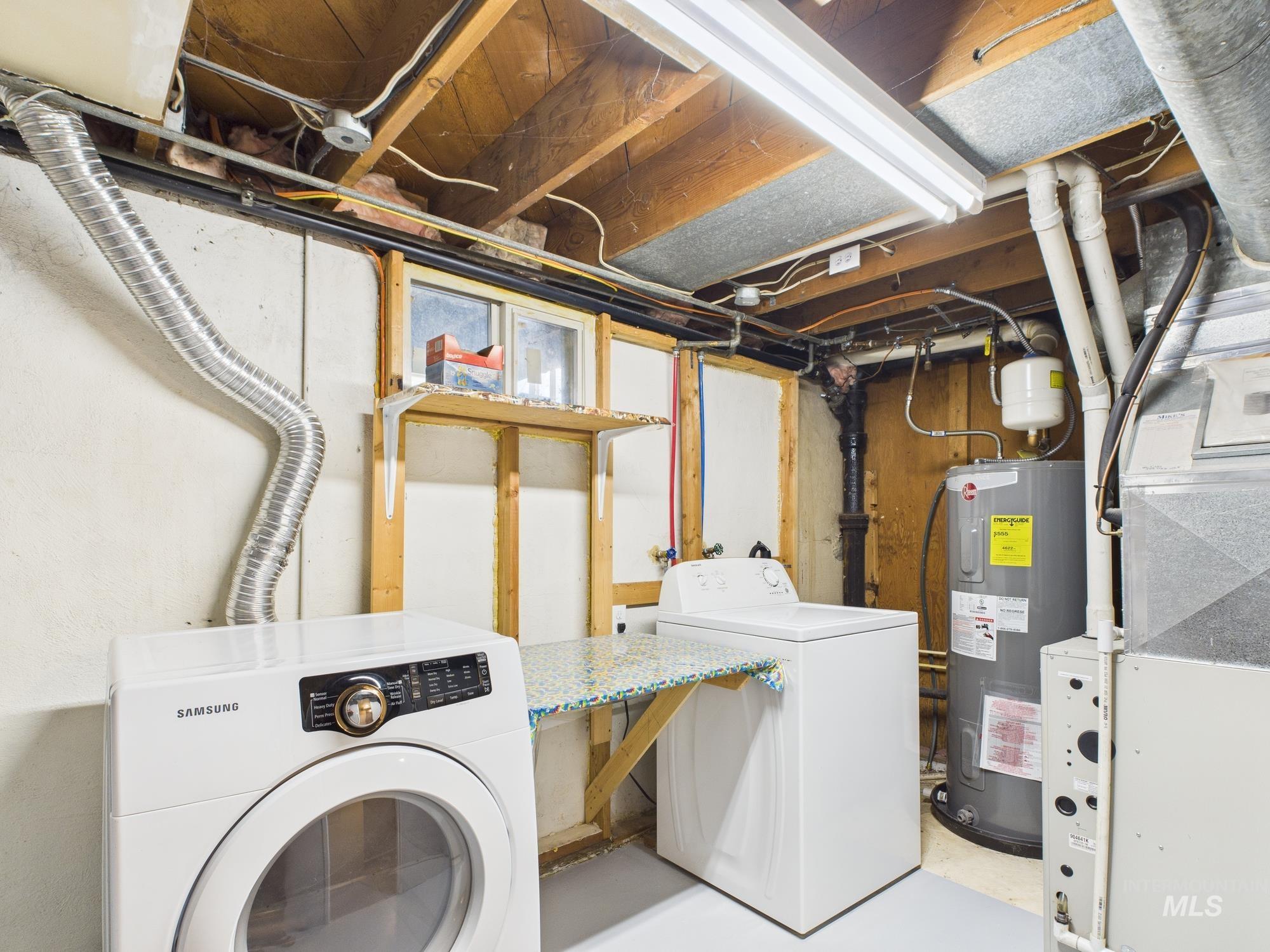 Washroom with electric water heater, heating unit, and separate washer and dryer
