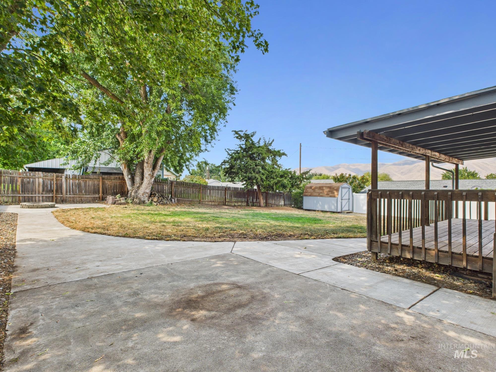 Fenced backyard with a shed