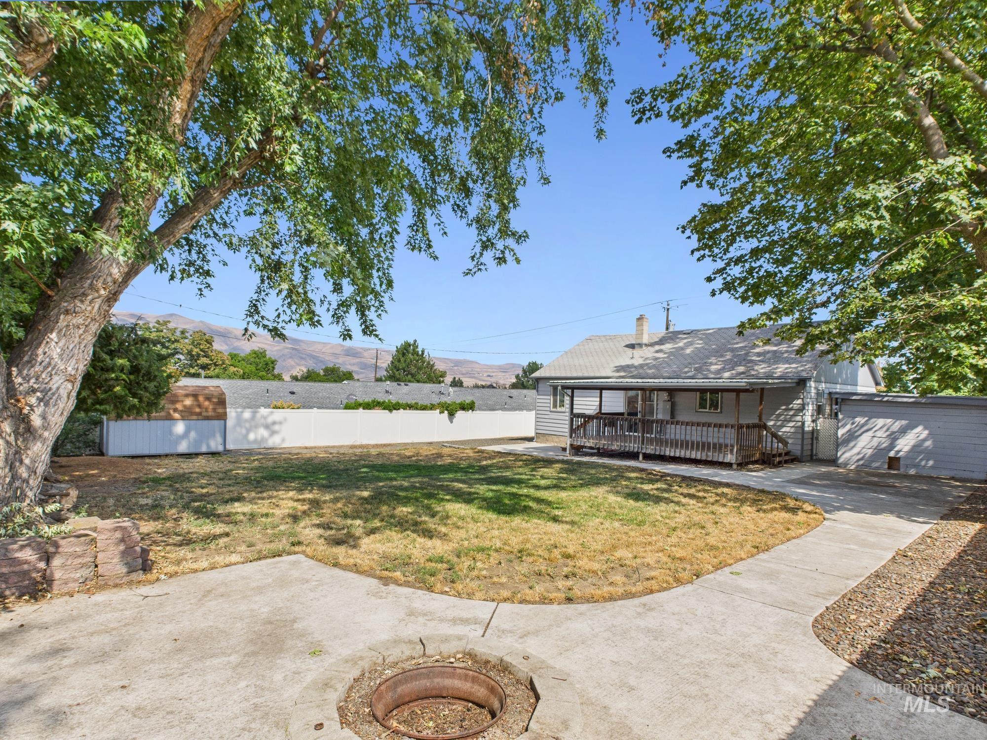 View of yard with a storage unit and a porch