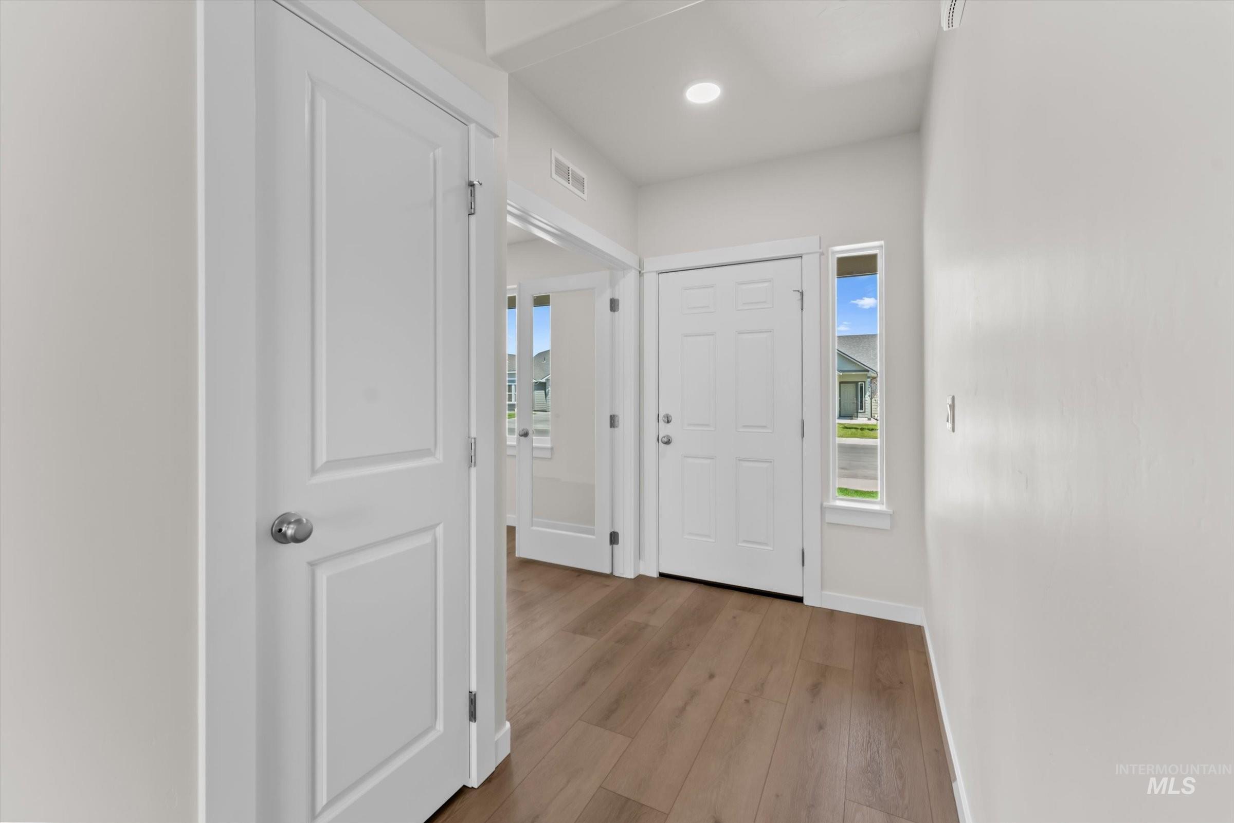 Foyer featuring light wood finished floors and recessed lighting