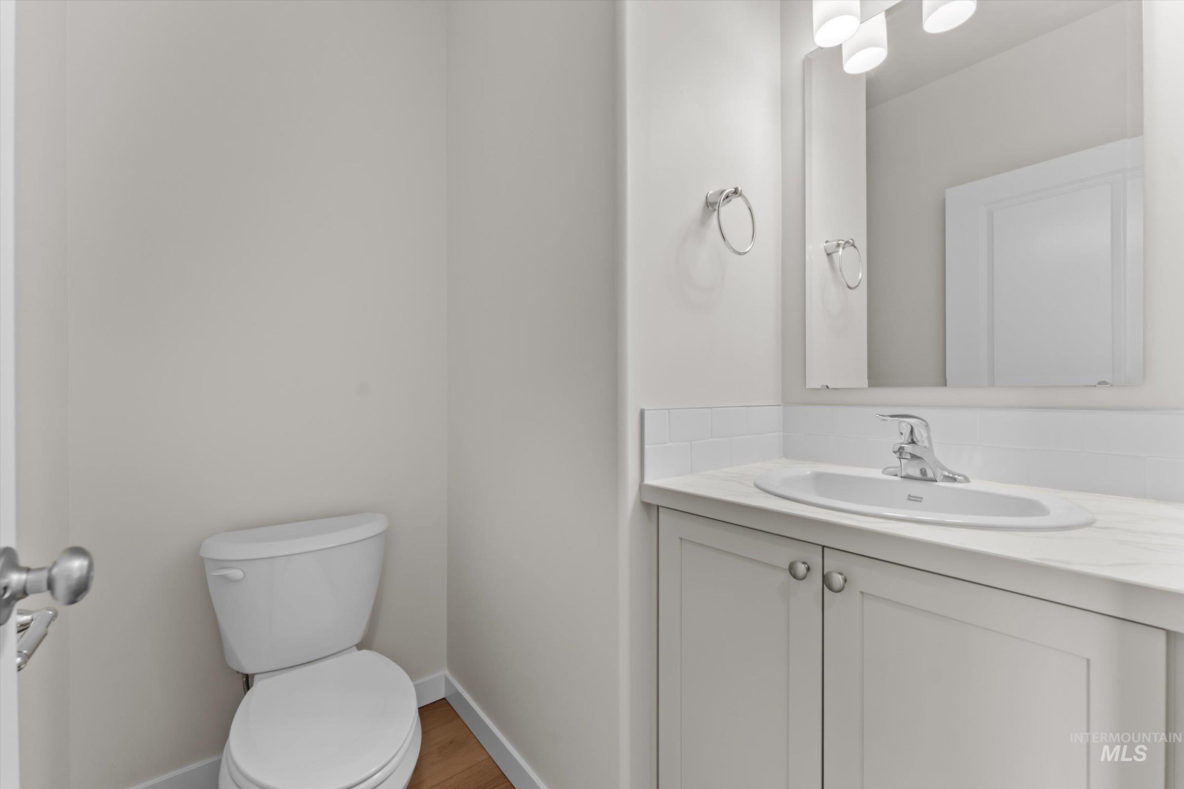 Bathroom featuring vanity and light wood finished floors