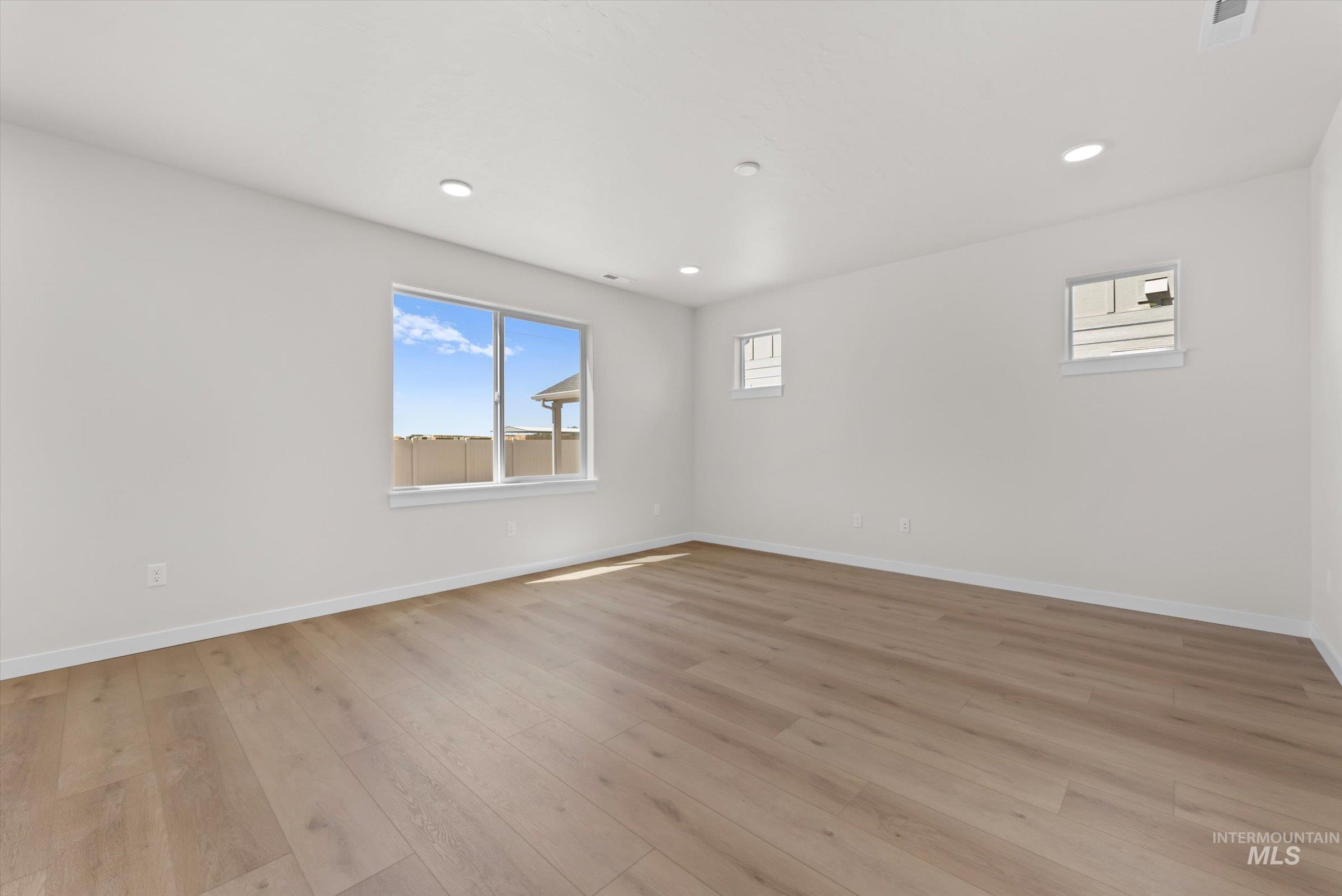 Unfurnished great room with light wood-style flooring and recessed lighting