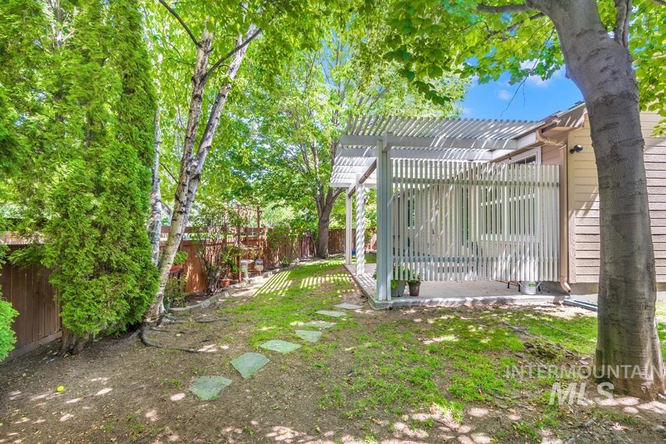 Fenced backyard with a pergola