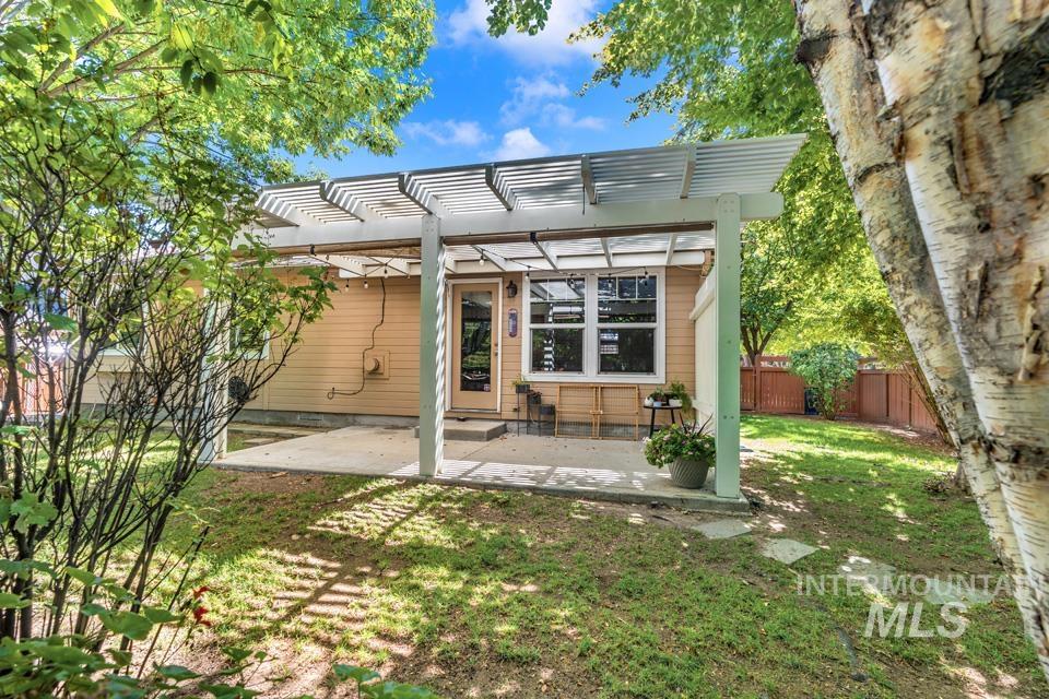 Back of property featuring a pergola and a patio