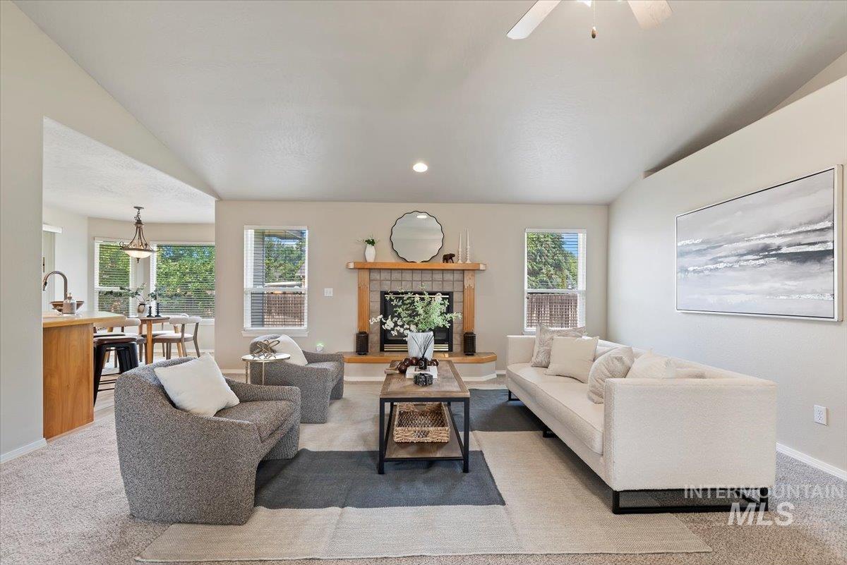 Carpeted living room with a fireplace and recessed lighting