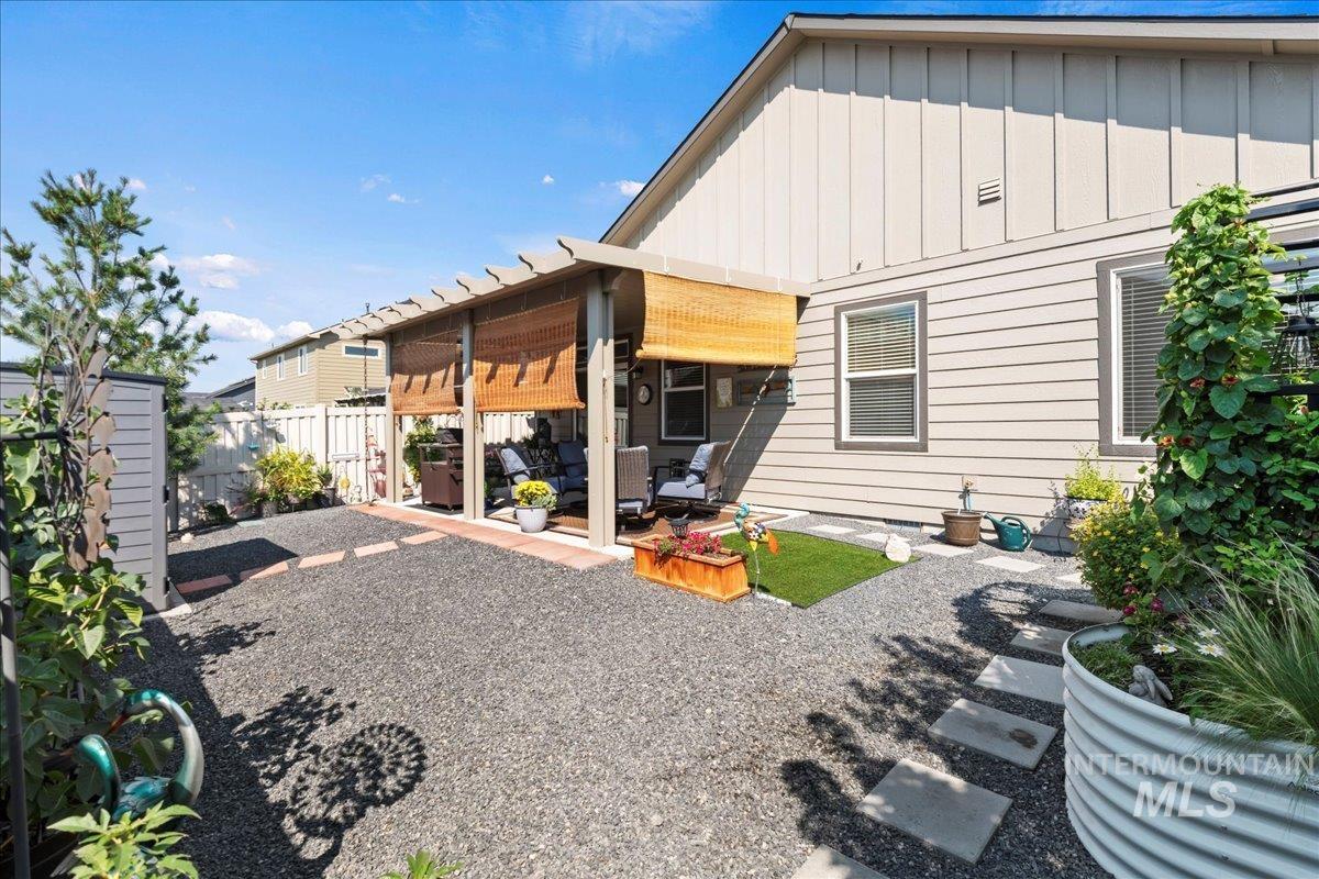 Rear view of house with board and batten siding and a patio