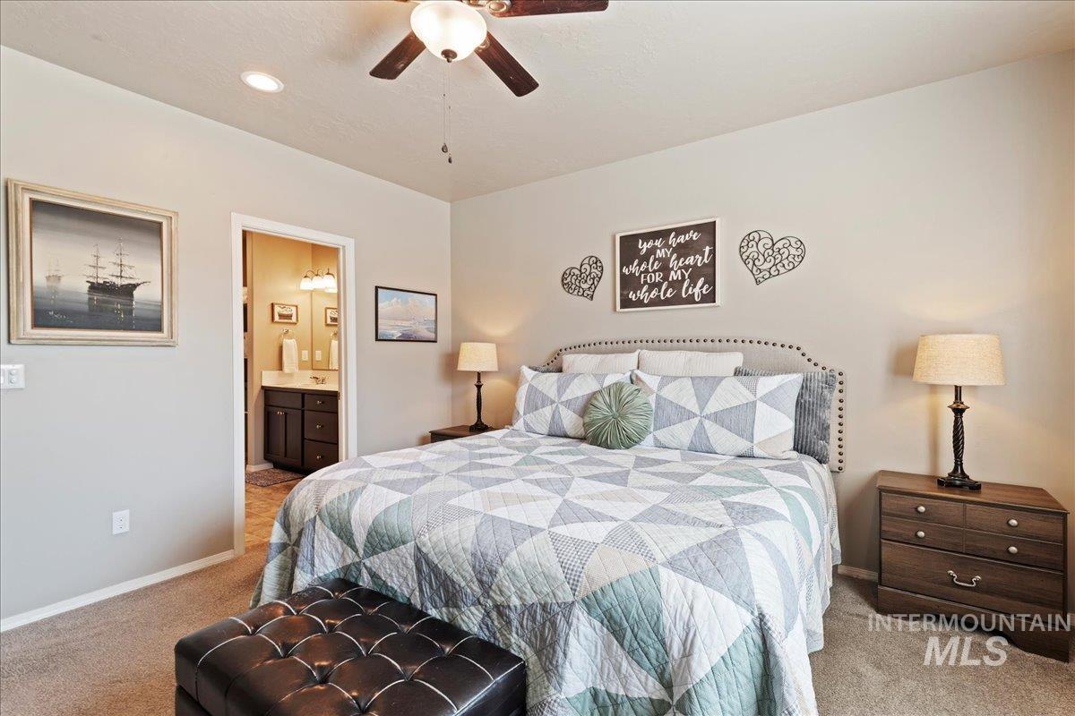 Bedroom featuring light colored carpet, ensuite bathroom, recessed lighting, and ceiling fan