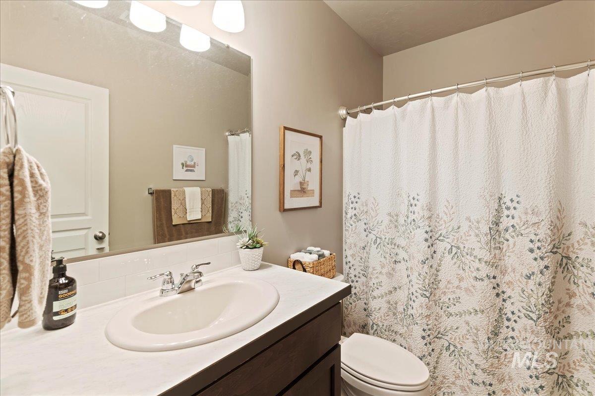 Bathroom with vanity and curtained shower