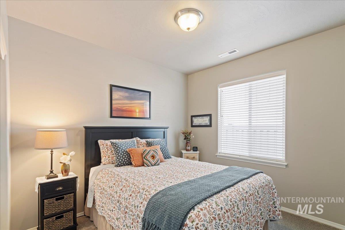 Carpeted bedroom with baseboards
