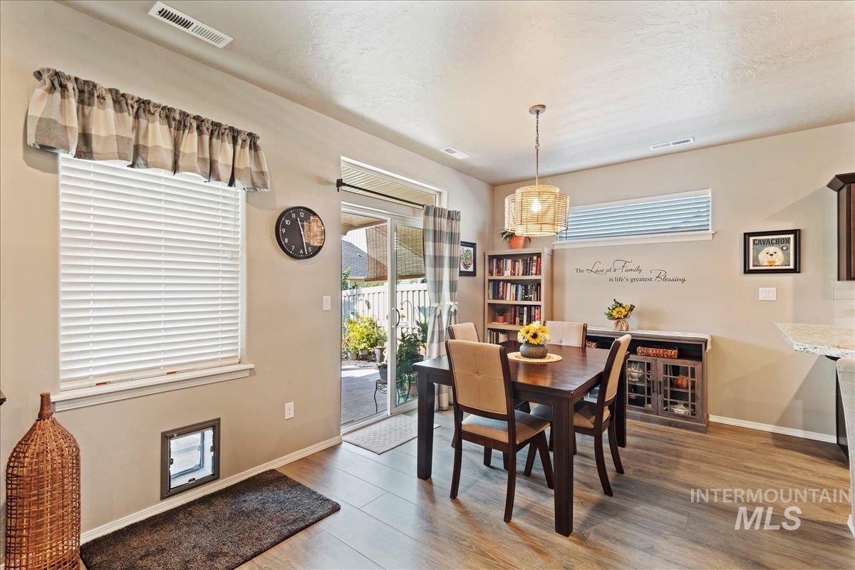 Dining space featuring light wood finished floors and a textured ceiling