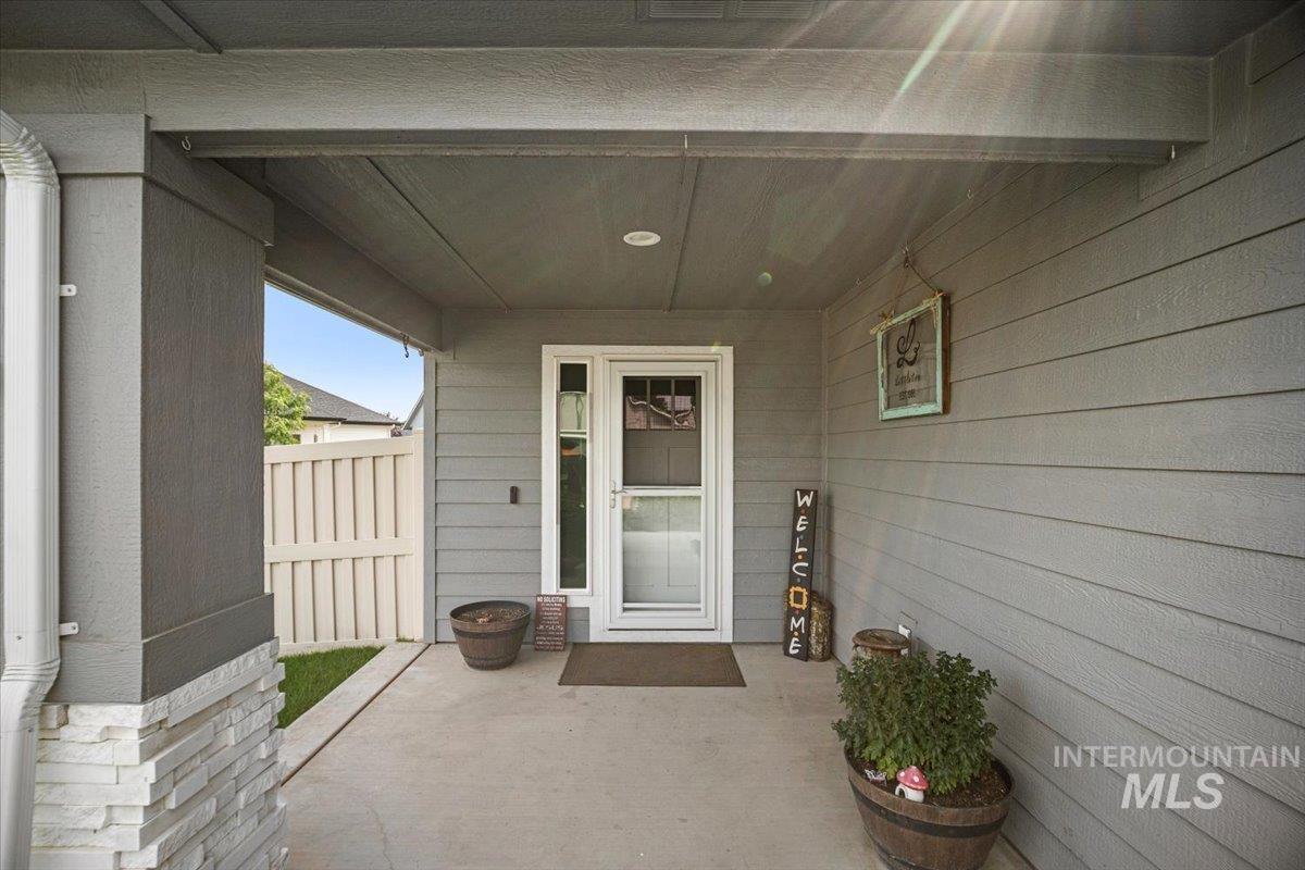 Property entrance with a patio area