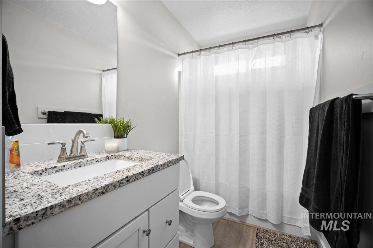 Bathroom featuring vanity, light wood-style floors, and a textured ceiling