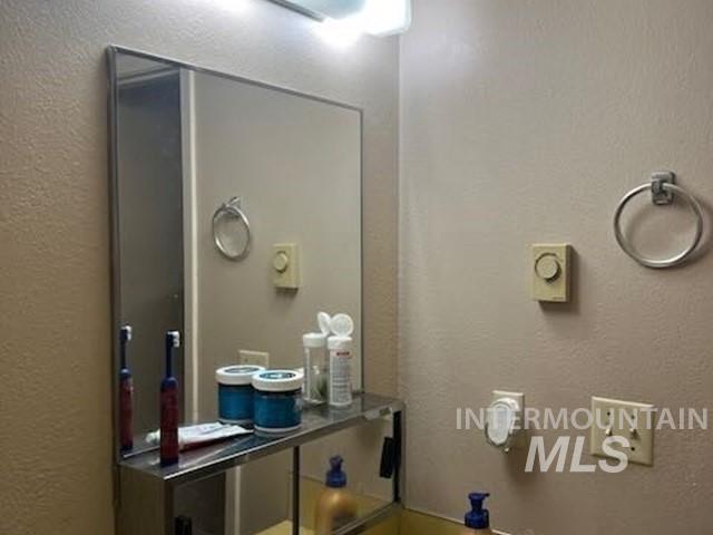 Bathroom featuring a textured wall