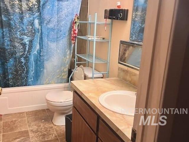 Bathroom featuring shower / tub combo with curtain and vanity
