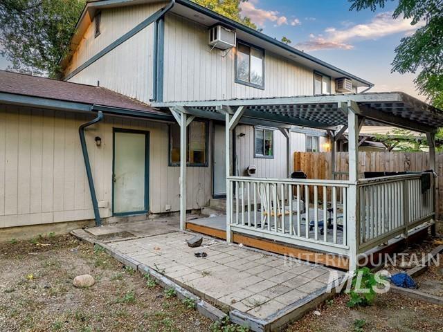 Rear view of property featuring a patio and a deck