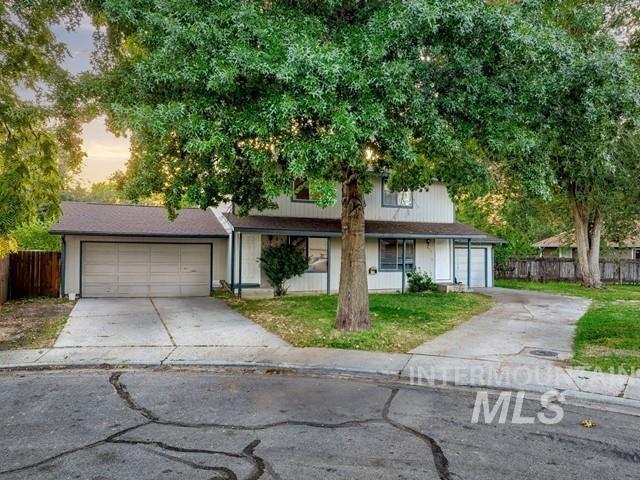 View of front facade with concrete driveway, a garage, and a porch