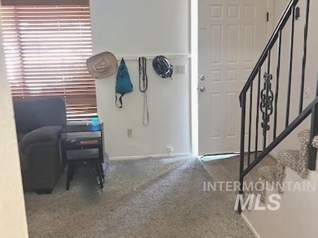 Entryway with carpet flooring and stairs