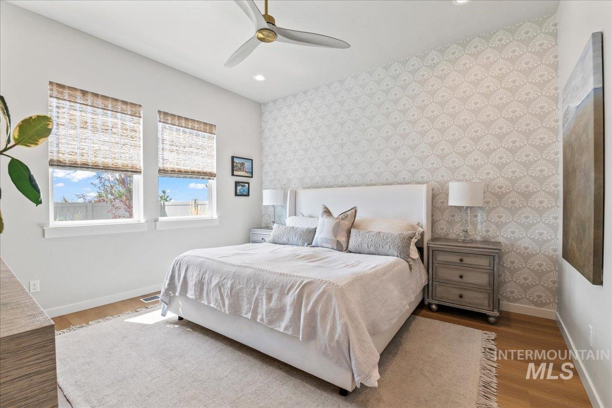 Bedroom with recessed lighting, wood finished floors, a ceiling fan, and wallpapered walls
