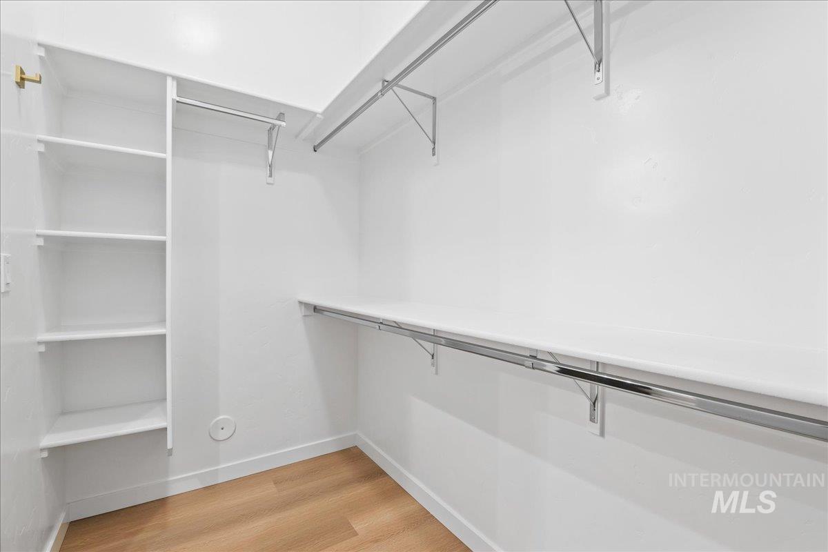 Spacious closet with light wood-style floors