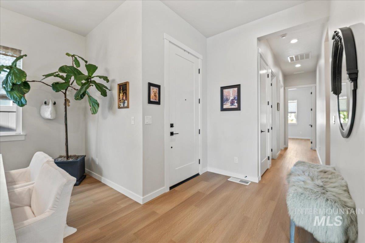 Foyer with plenty of natural light, light wood-style floors, and recessed lighting