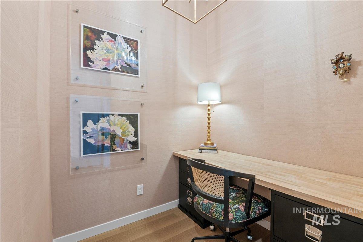 Office space with baseboards and wood finished floors