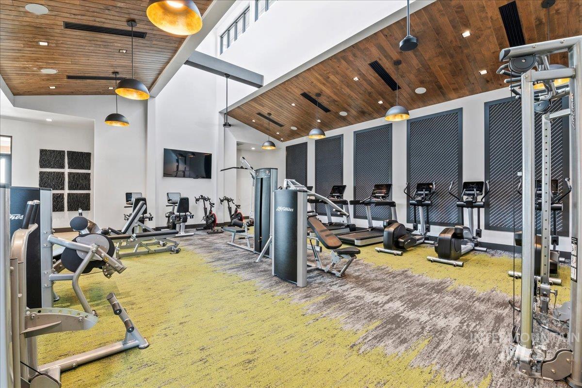 Exercise room featuring carpet floors, high vaulted ceiling, wooden ceiling, and recessed lighting