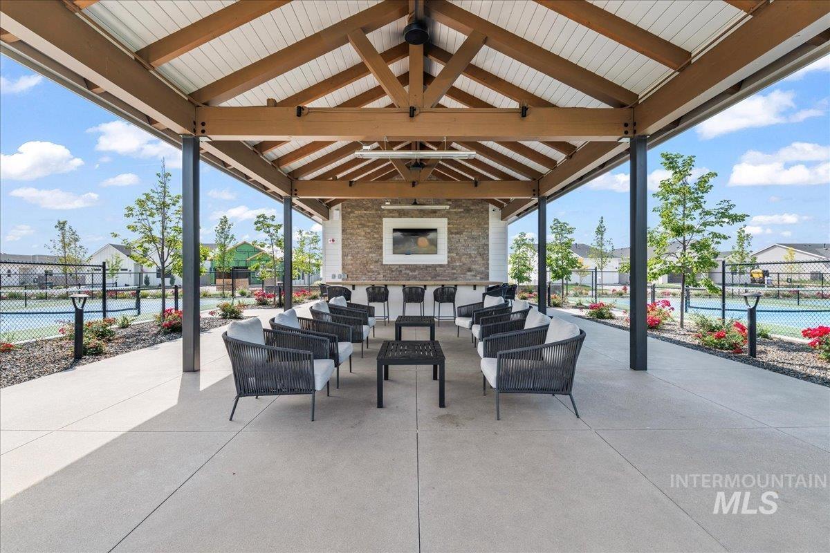 View of patio with an outdoor living space with a fireplace
