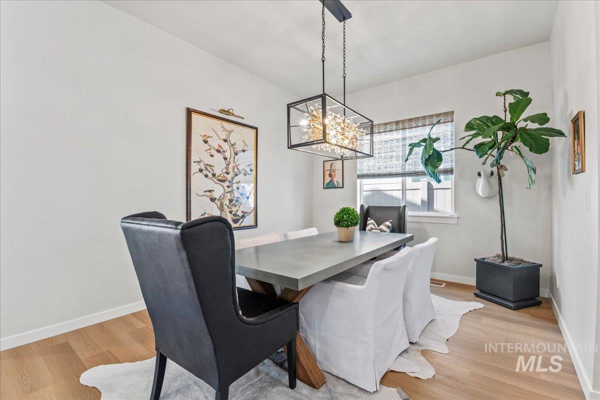 Dining room featuring light wood-style floors and a chandelier