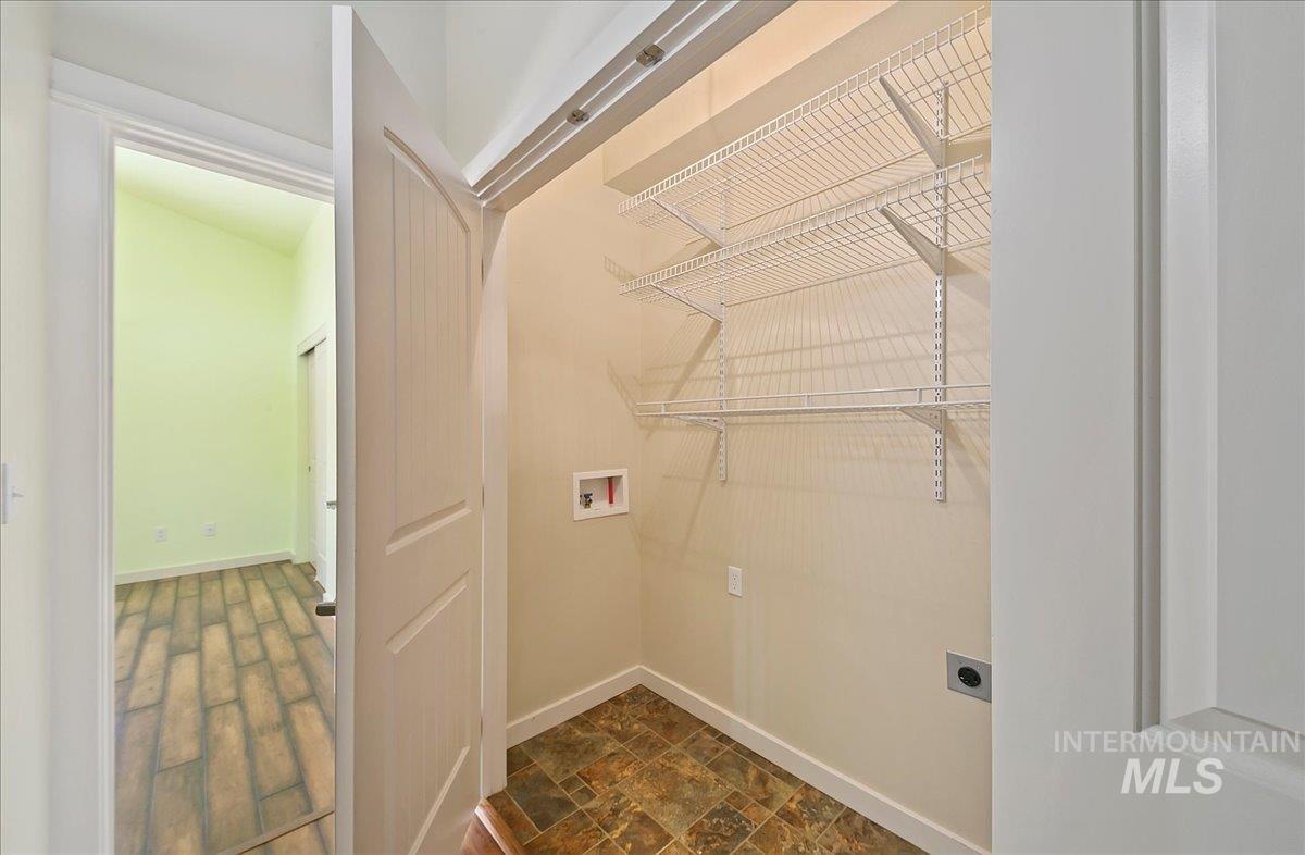 Laundry area featuring washer & dryer hookup and Storage Shelves.  There is a washer/dryer set that is included and will stay!
