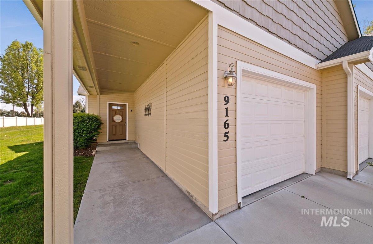 View of exterior entry with a garage