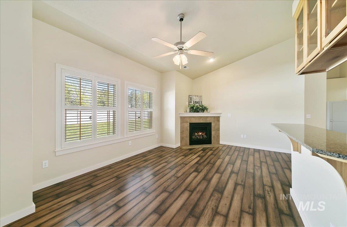 This Great Room has a bumped out window alcove, Lovely Plantation Style Window Blinds, There's a Breakfast Bar & Decorative Glass Cabinet to store & display all your favorite Keepsakes!