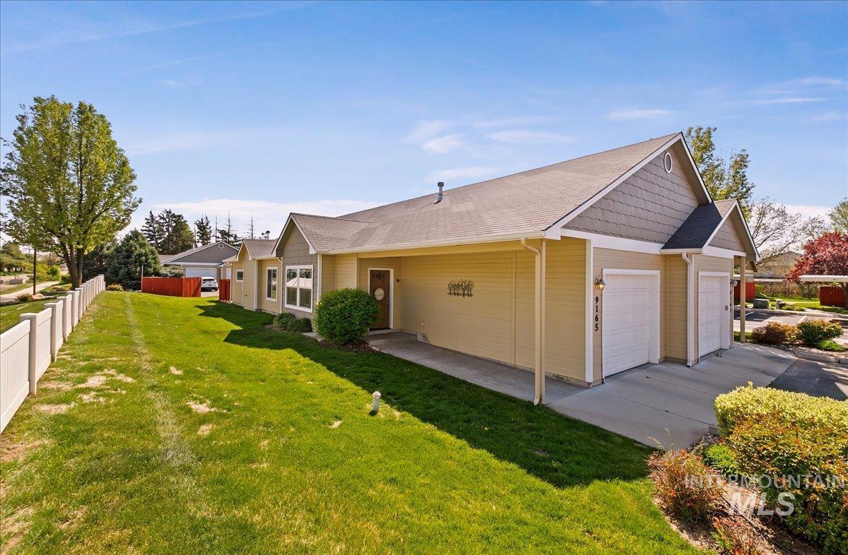 View of property exterior with an attached garage and concrete driveway