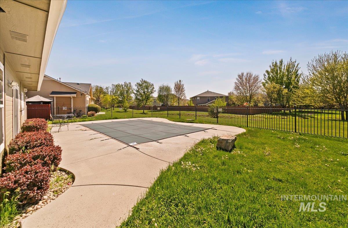 View of pool featuring a full safety fence