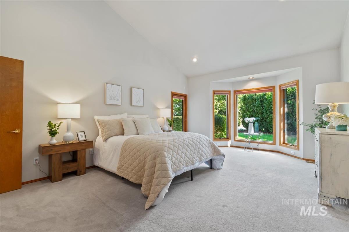 Bedroom featuring carpet floors, high vaulted ceiling, and recessed lighting