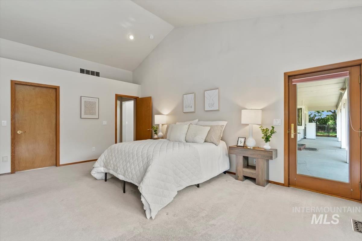 Bedroom featuring high vaulted ceiling, carpet, recessed lighting, and access to exterior
